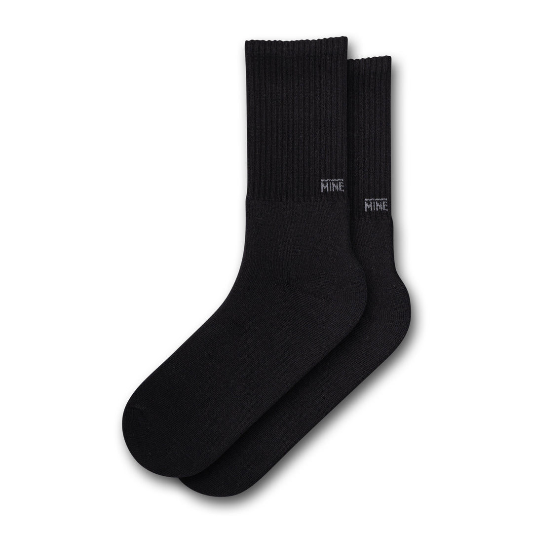 Black socks with "Mine" branding on the lower ankle