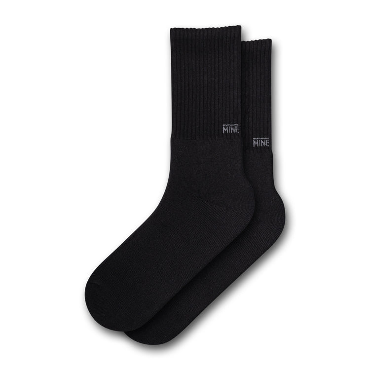 Black socks with "Mine" branding on the lower ankle