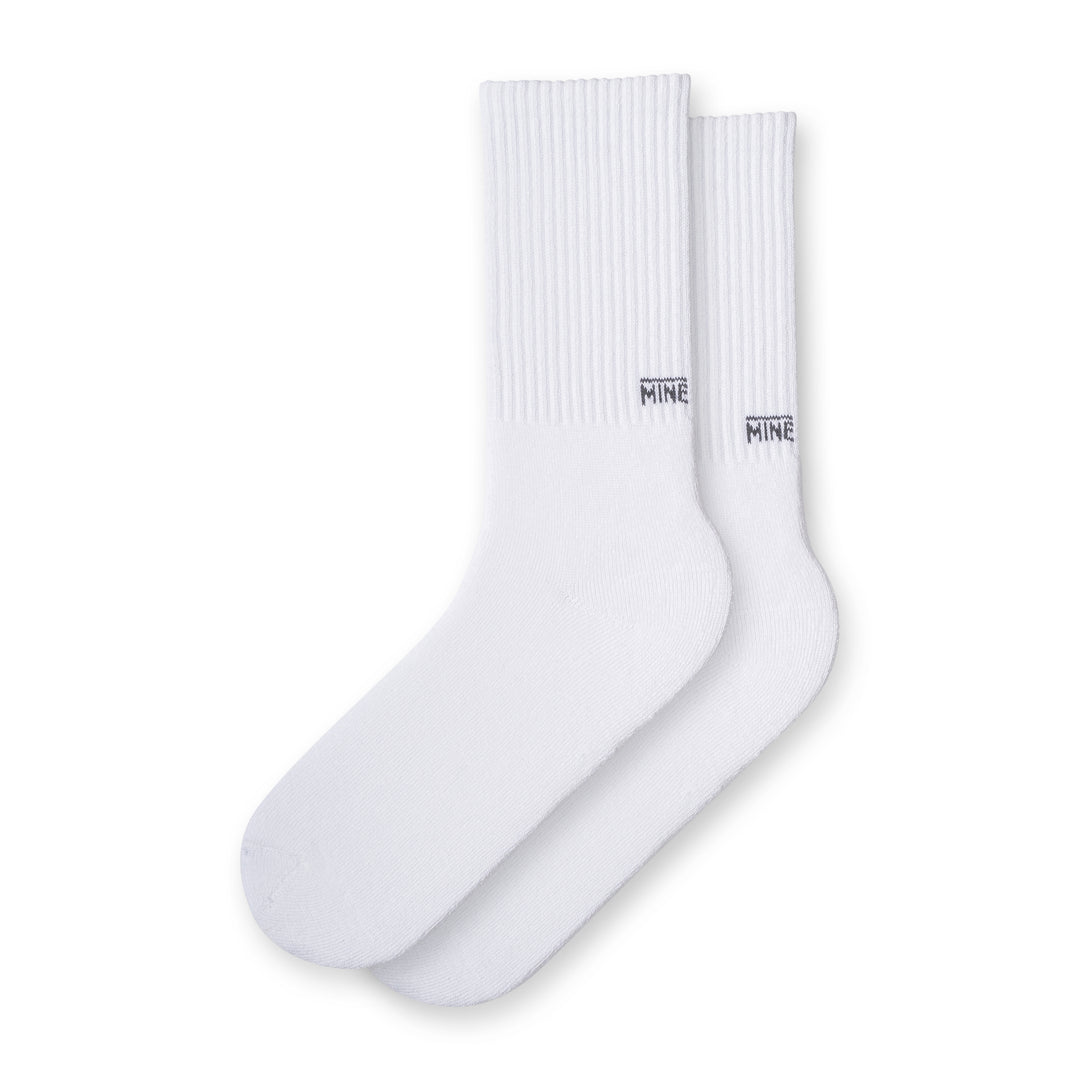 White socks with "MINE" branding on lower ankle
