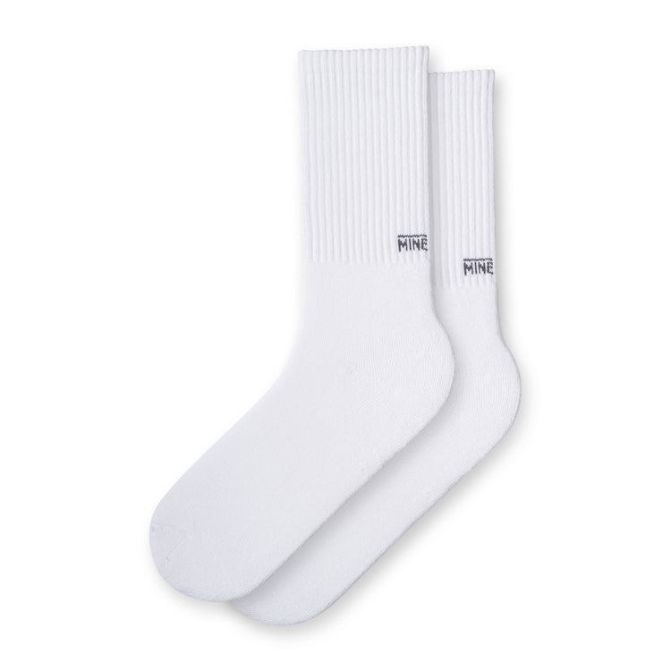 White socks with "MINE" branding on lower ankle