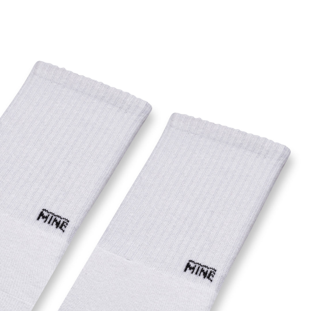 White socks with "MINE" branding on lower ankle