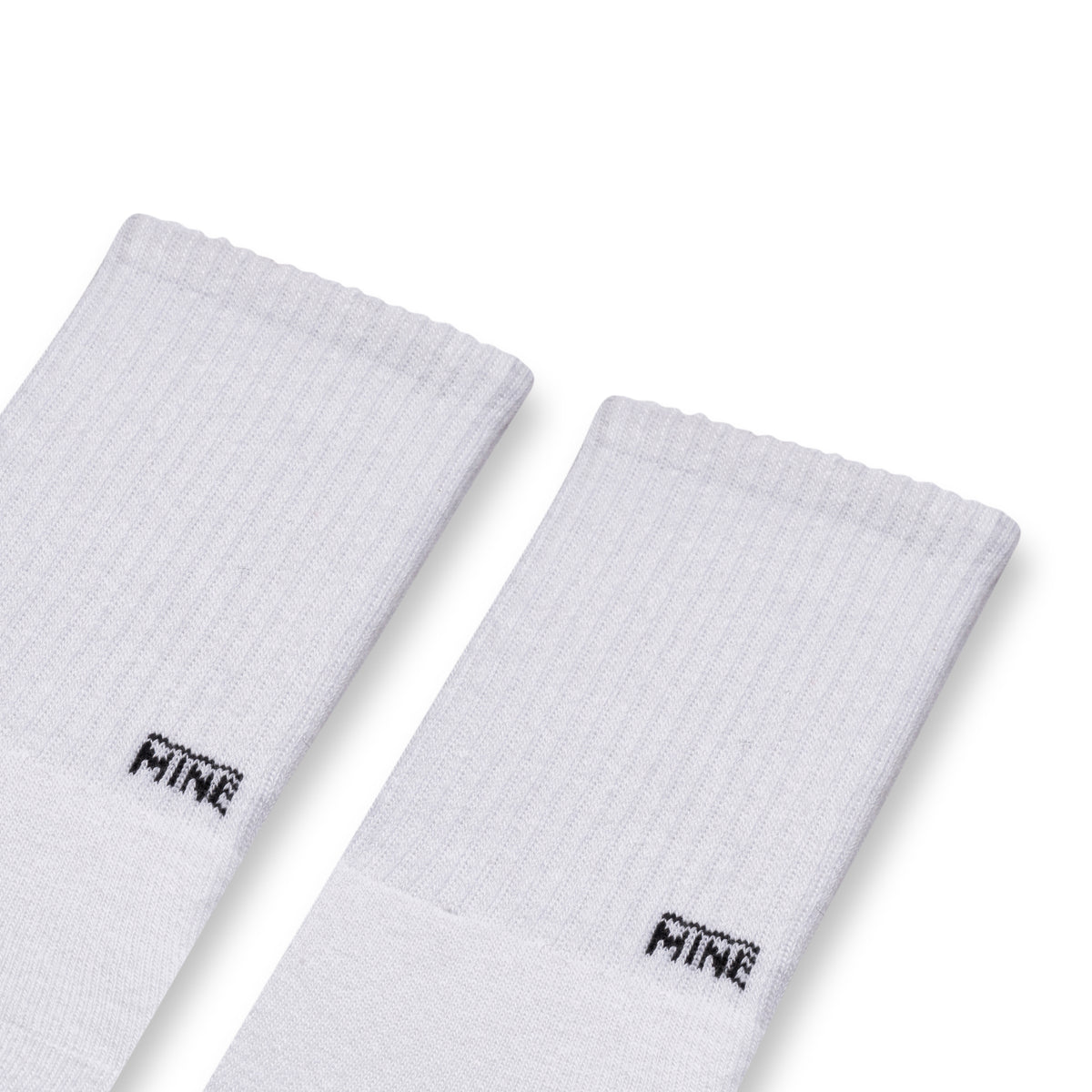 White socks with "MINE" branding on lower ankle