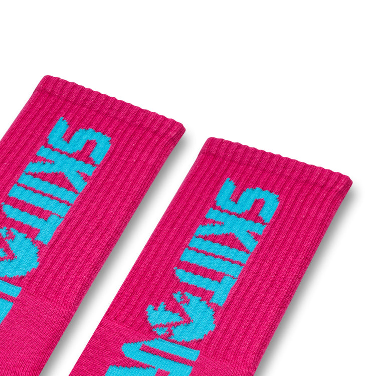 A pair of pink and blue colored socks with 'Skiitour' branding on the ankle area.