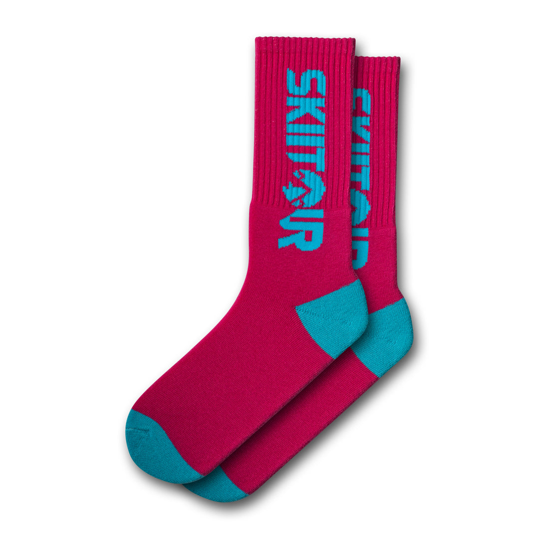 A pair of pink and blue colored socks with 'Skiitour' branding on the ankle area.