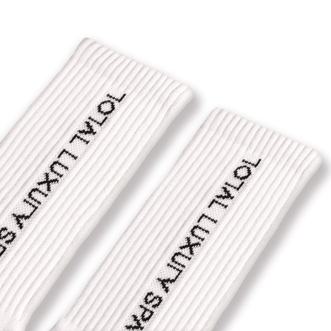 White socks with "total luxury spa" branding