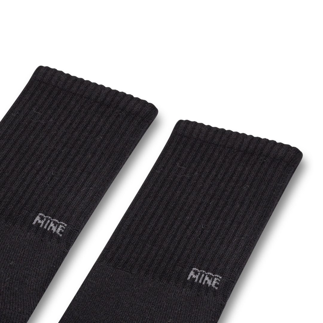 Black socks with "Mine" Branding on the lower ankle