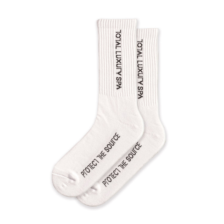 White socks with "total luxury spa" branding