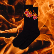 A pair of black socks with a flaming dice design with flaming background