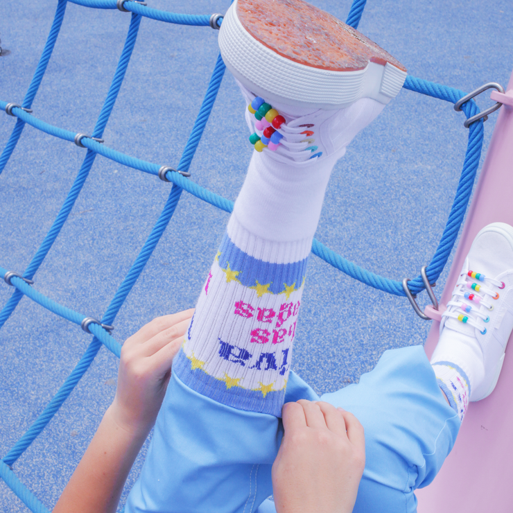 A pair of white socks with blue and yellow &