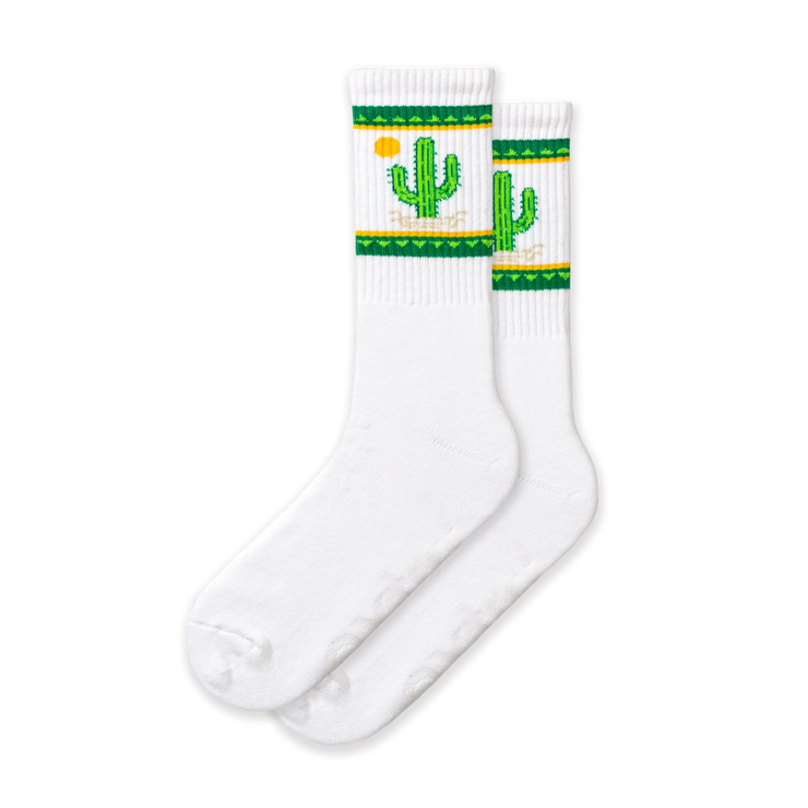 A pair of white socks with green and yellow cactus designs and a small cactus flower detail.