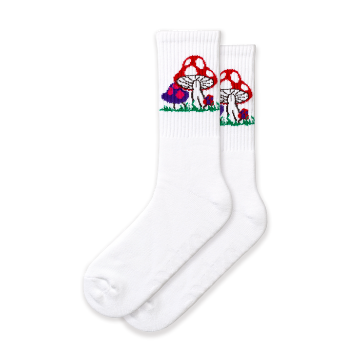 A pair of white crew socks with a mushroom design, featuring various mushroom shapes and a field of colorful flowers.