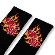 A pair of black socks with a flaming dice design.