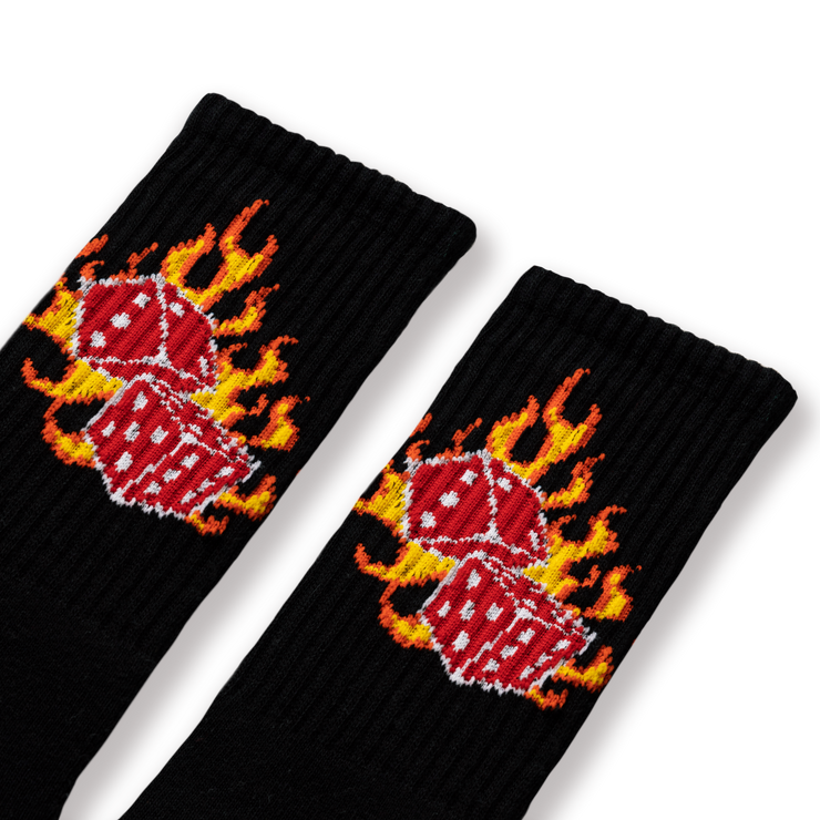 A pair of black socks with a flaming dice design.